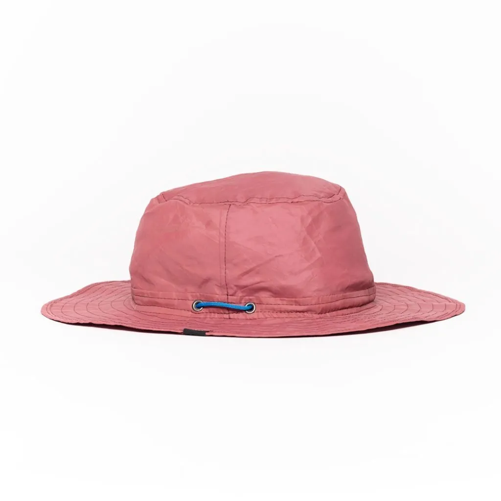 Pink upcycled hat with blue drawstring and wide brim.