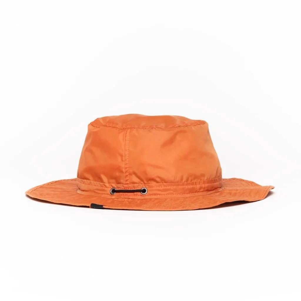 Vibrant orange bucket hat with adjustable chin strap and wide brim.