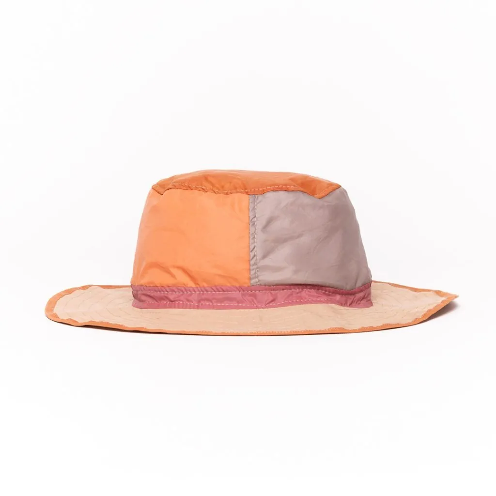 Colorful upcycled hat with wide brim and patchwork design.