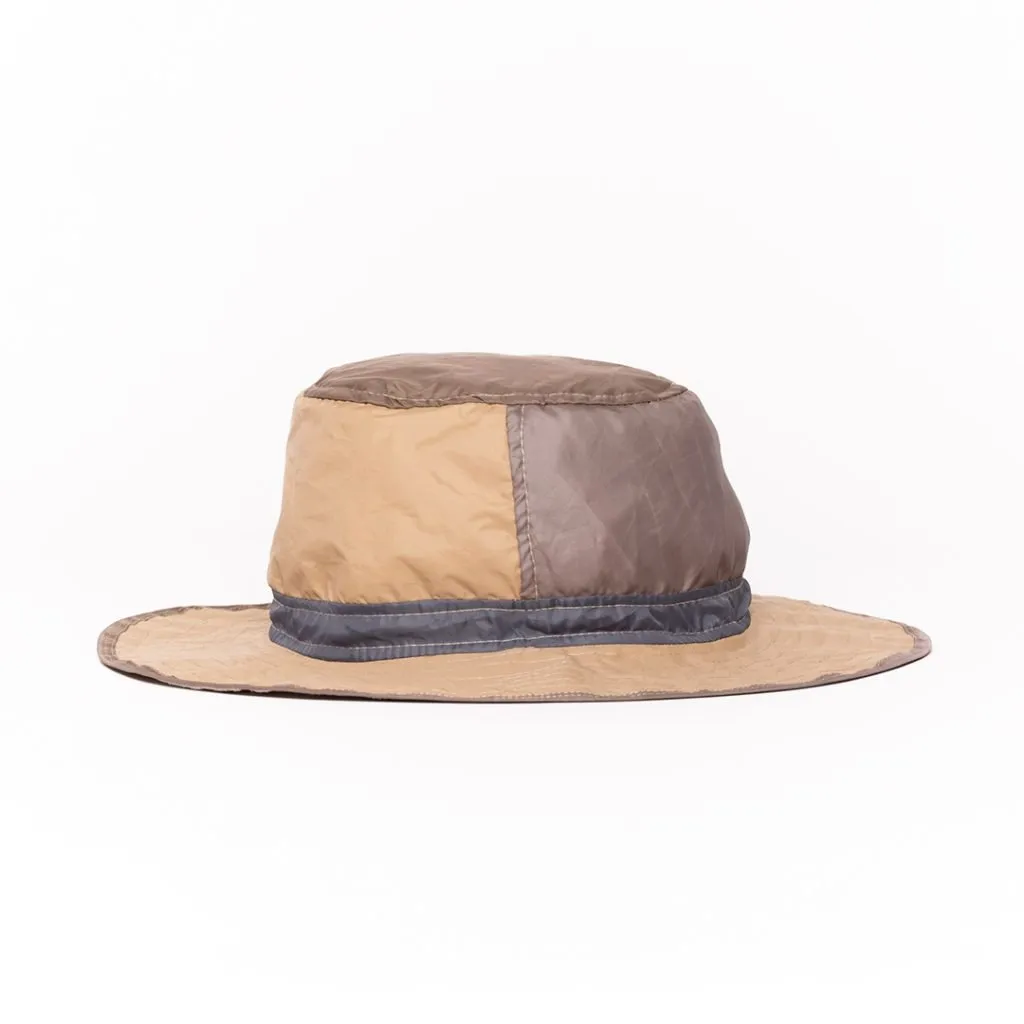 Upcycled hat with brown, beige and gray colors. Wide brim and patchwork design.