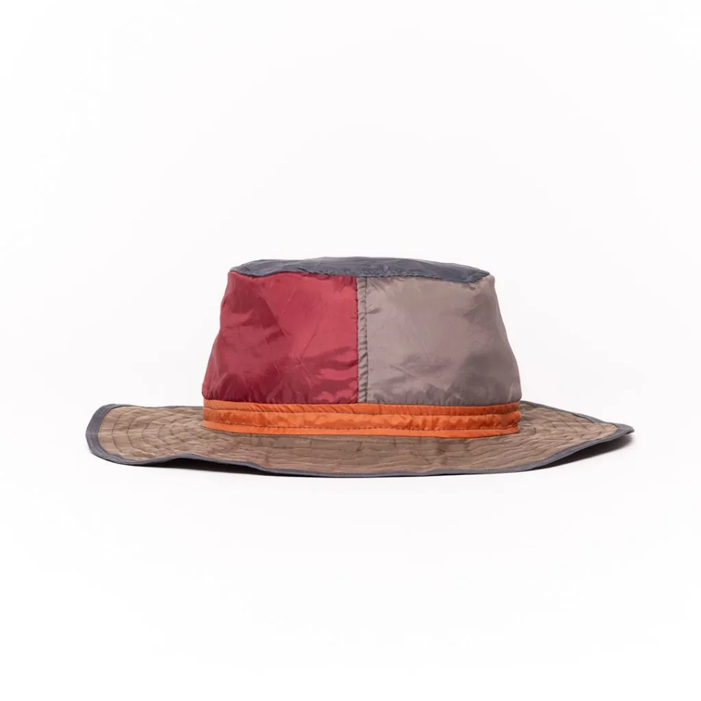 Colorful upcycled hat with patchwork design and wide brim.