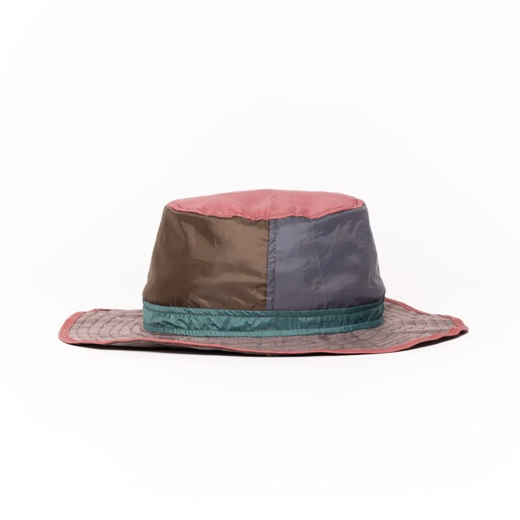 Colorful upcycled hat with patchwork design and wide brim.