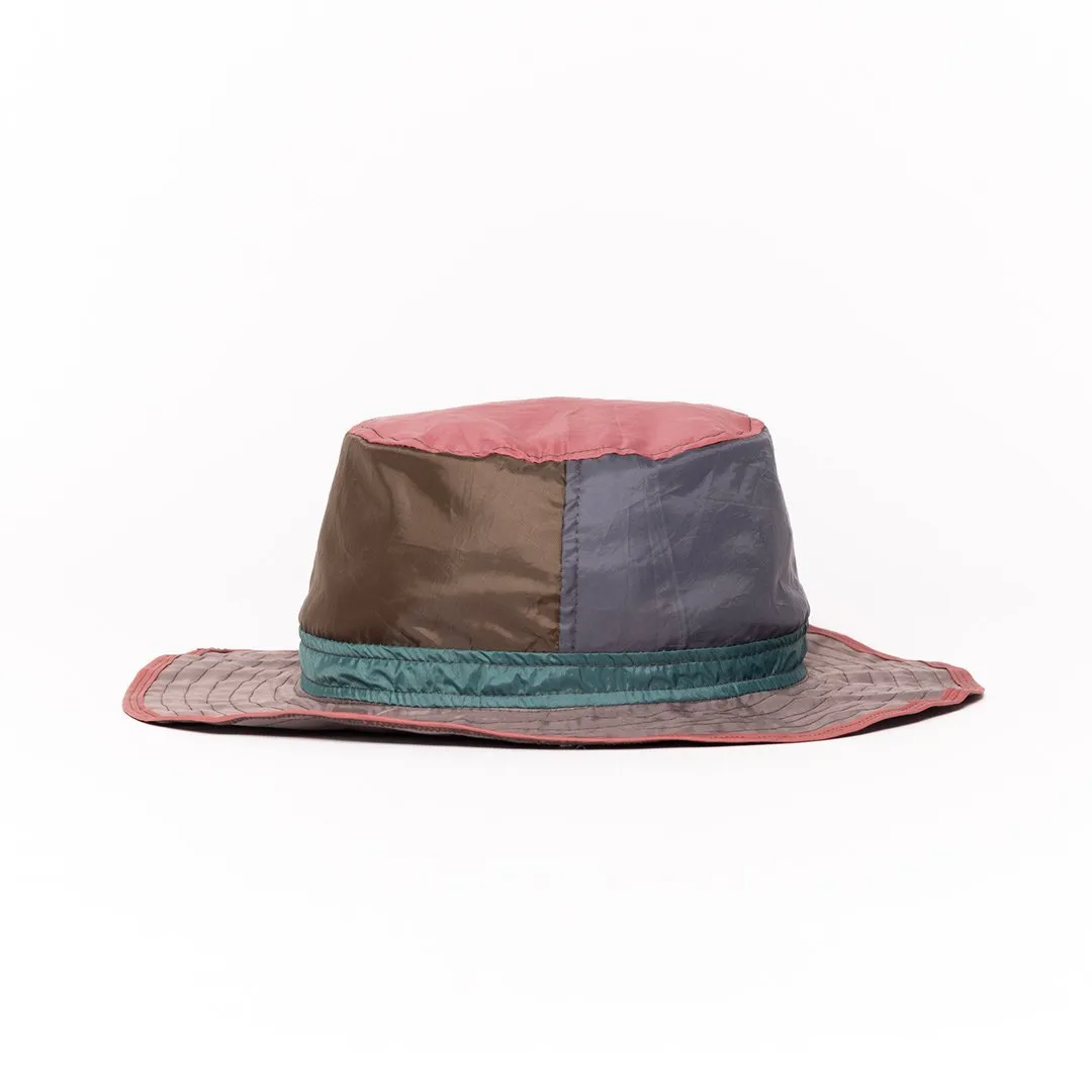 Colorful upcycled hat with patchwork design and wide brim.