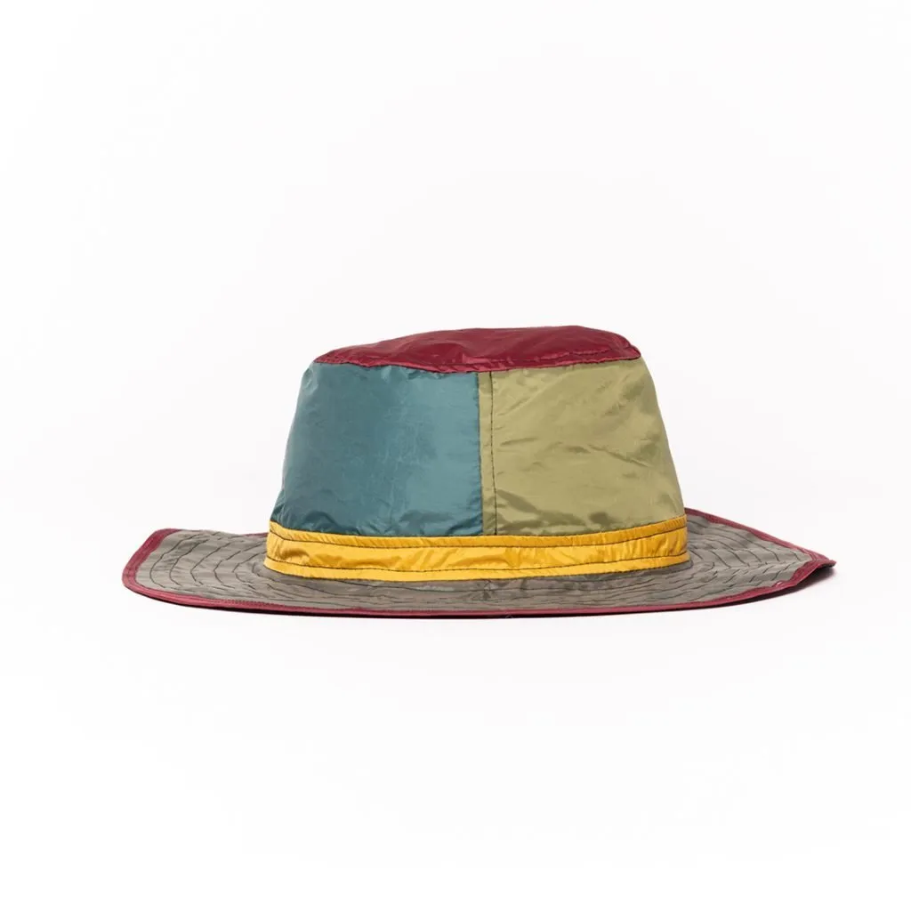 Colorful upcycled hat with patchwork design and wide brim.