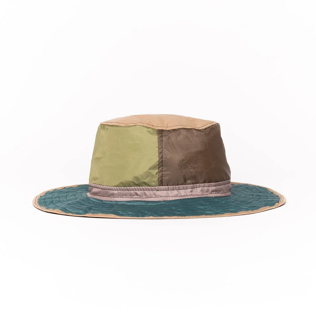 Upcycled colorful bucket hat with patchwork design and wide brim.